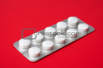 blister pack containing tablets on a red background