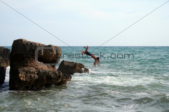 two men jumping into the water