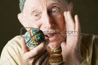 Man contemplating a rubber band ball