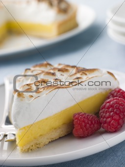 Slice Of Lemon Meringue Pie With Raspberries