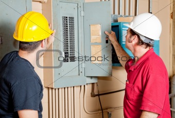 Repairmen Examine Electrical Panel