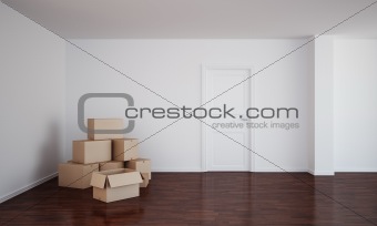 Empty room with cardboard boxes and dark floor