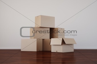 Cardboard boxes in empty room with dark floor