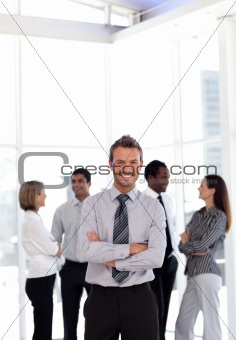 Portrait of a happy young businessman with arms crossed