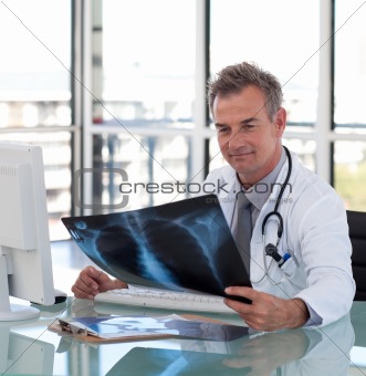 Mature Doctor looking at an x-ray