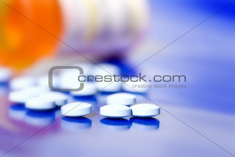 Bottle of medication pills next to prescription bottle