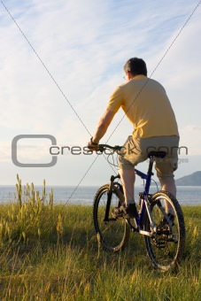 Man riding bicycyle at the sea