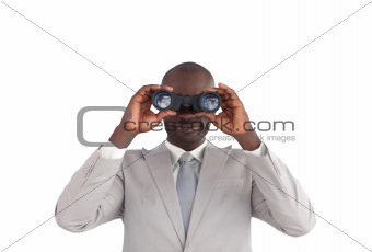 Business man looking through binoculars