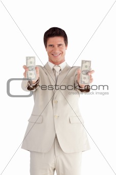Businessman holding Dollars