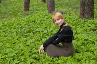 Blond beautiful girl in the spring forest.