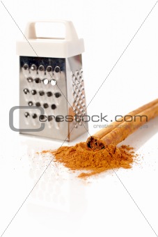 Sticks, powder of cinnamon and grater