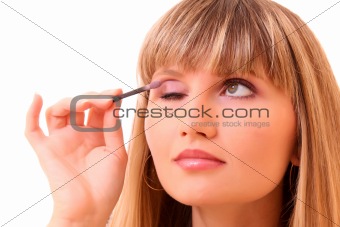 Young woman make up her eyebrow isolated on white