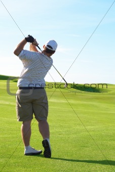 Young golfer on the fairway