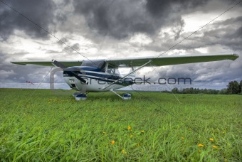 Aircraft on the field against thunderstorm clouds background