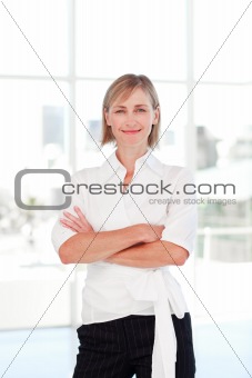 Blonde businesswoman with folded arms