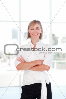 Blonde businesswoman with folded arms