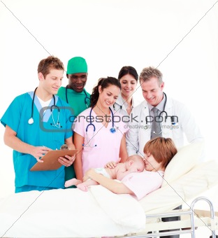 Doctors with a mother and her newborn baby