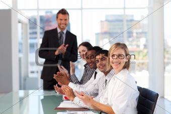 Happy manager clapping in a presentation