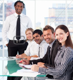 Happy business leader with his team in a meeting