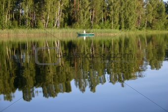 Fisherman on the calm lake