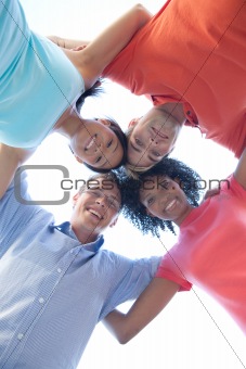 group of happy friends huddling