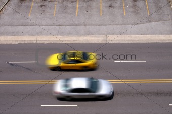 Cars Pass In Blurred Motion