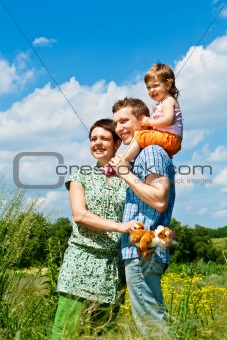 Parents and their daughter in meadow