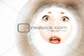 woman looks through a pipe