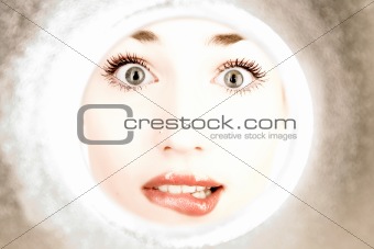 woman looks through a pipe
