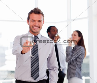 Businessman drinking champagne and celebrating a success 