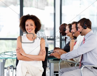 Smiling female manager working in a call center