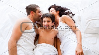 Couple and son lying in bed