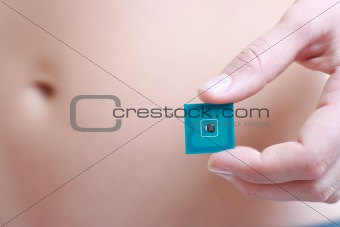 A studio shot of a woman holding in her hand Radio-frequency ide