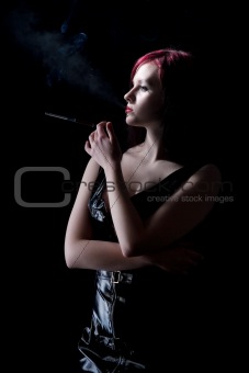 beautiful woman smokes a cigarette with a mouthpiece