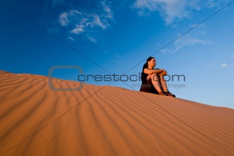 Woman admiring Coral Pink Sand Dunes State Park in Utah