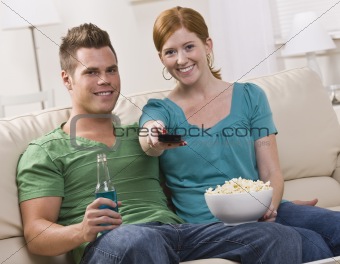 Attractive couple watching TV