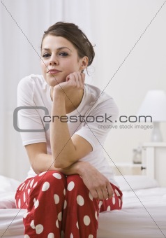Woman on Bed Wearing Red Polka Dot Pajamas