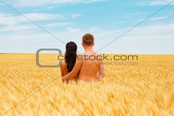 Couple standing in a wheat field
