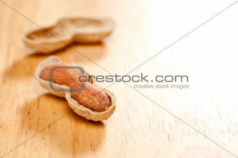 Peanuts on Wood Background with Dramatic Lighting.