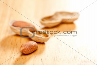 Peanuts on Wood Background with Dramatic Lighting.
