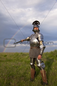 medieval knight in the field, and a rainbow