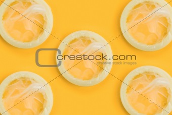 condoms on orange background