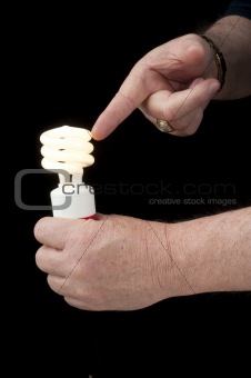 Man holding pigtail lightbulb