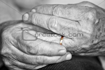 Old hands with wedding band