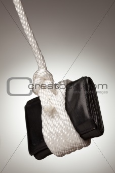 Tied Up and Hanging Wallet on a Spot Lit Background.