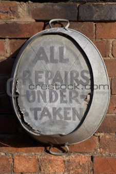 old tin bath hanging on a wall