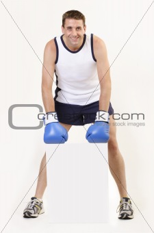 Boxer with blue gloves holding a white board 3