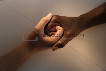 White female and Black African holding hands