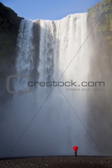 Woman With a Red Umbrella By A Waterfall