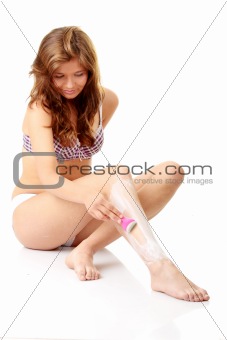 Woman depilating her legs